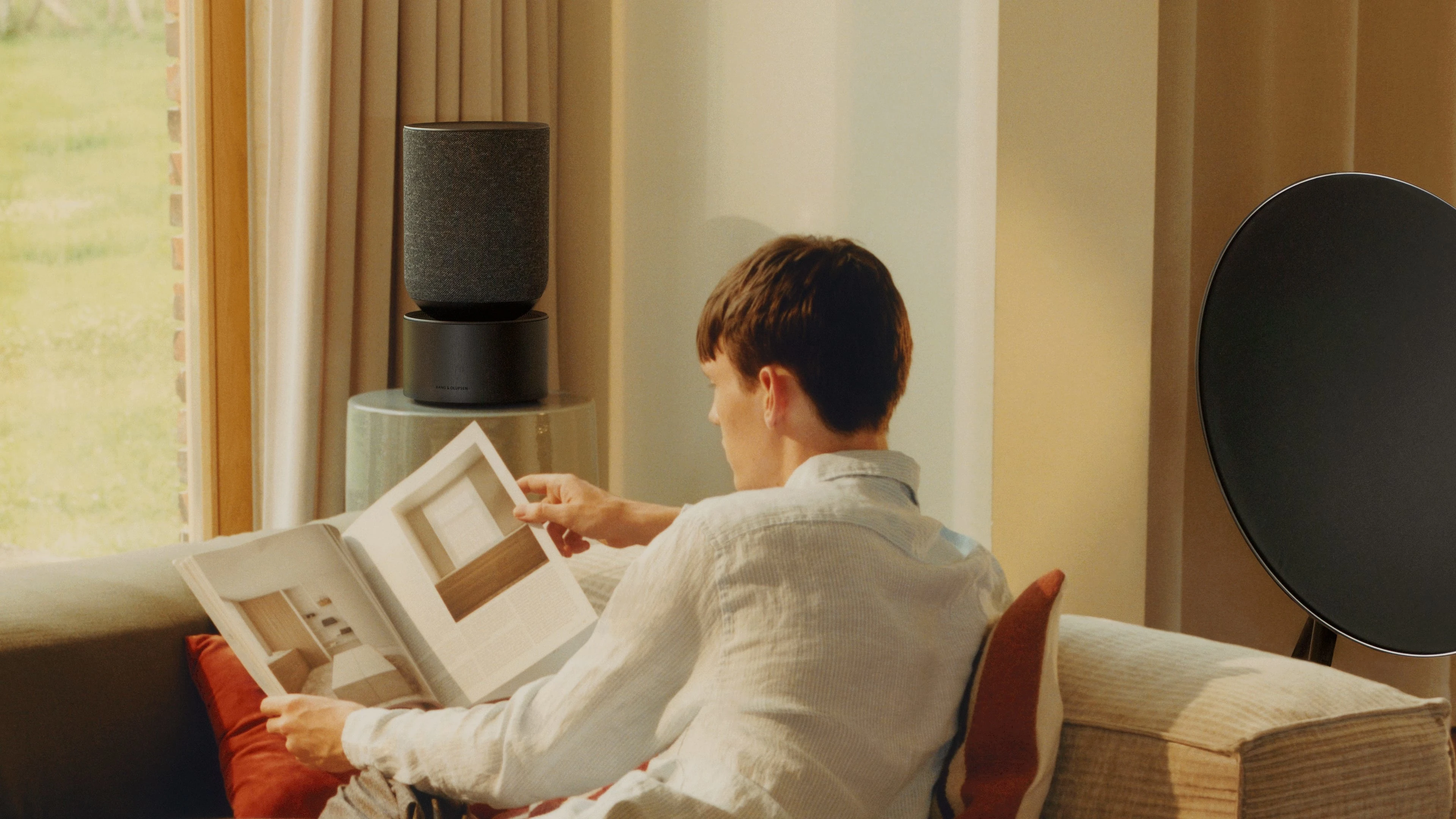 Person listening to music on Beosound Balance and Beosound A9